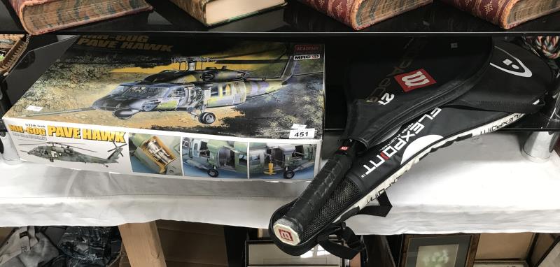 A helicopter model kit and 2 tennis rackets