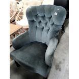 A deep buttoned armchair