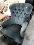 A deep buttoned armchair