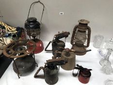 A collection of oil lamps including Tilly lamps, paraffin burners etc.