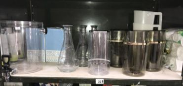 A shelf of wine coolers and water carafes