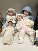 3 Leonardo porcelain baby dolls and one other doll