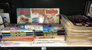 A shelf of comics and annuals including Dandy & Beano
