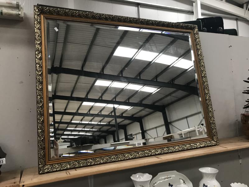 A large bevel edge mirror in gilt frame