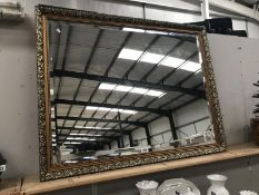 A large bevel edge mirror in gilt frame