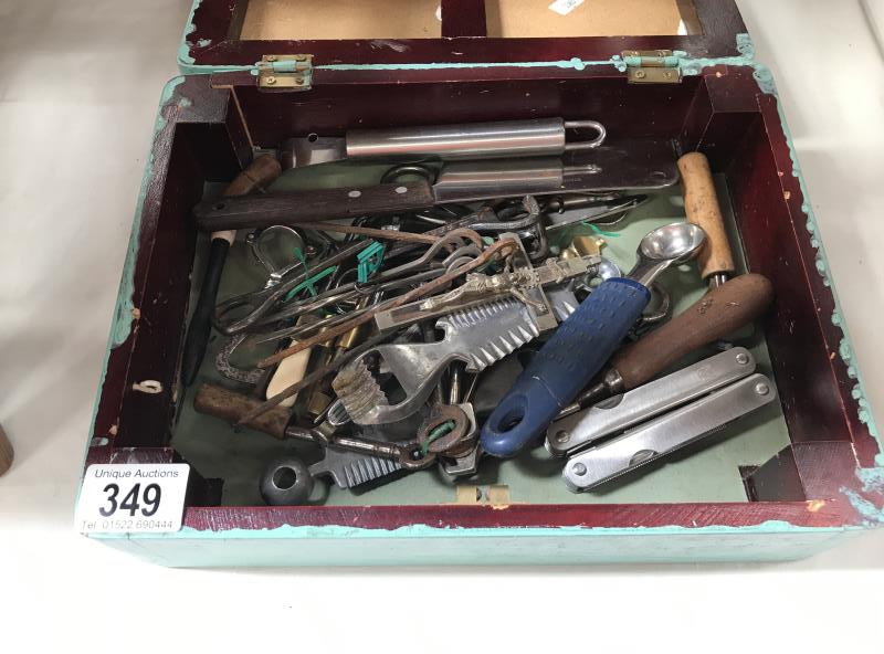 A box of miscellaneous including an old crucifix, skewers, bottle openers etc.