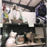 2 shelves of garden figures including gnome, meerkat, geese, pigs etc.