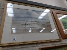 A framed and glazed watercolour beach scene, signed but indistinct.