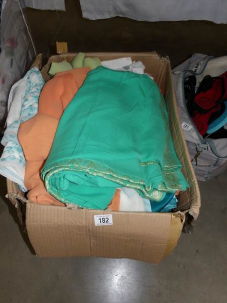 A large box of Indian tunics and other clothing.