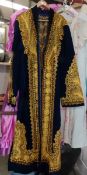 A long Indian robe embroidered with gold thread.