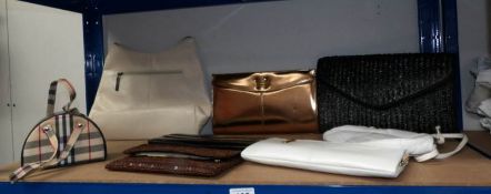 A quantity of clutch and hand bags.