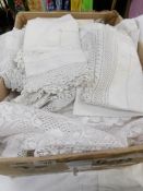 A box of vintage lace and table linen.