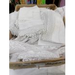 A box of vintage lace and table linen.