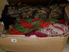 A large box of assorted sari's and shawls etc.