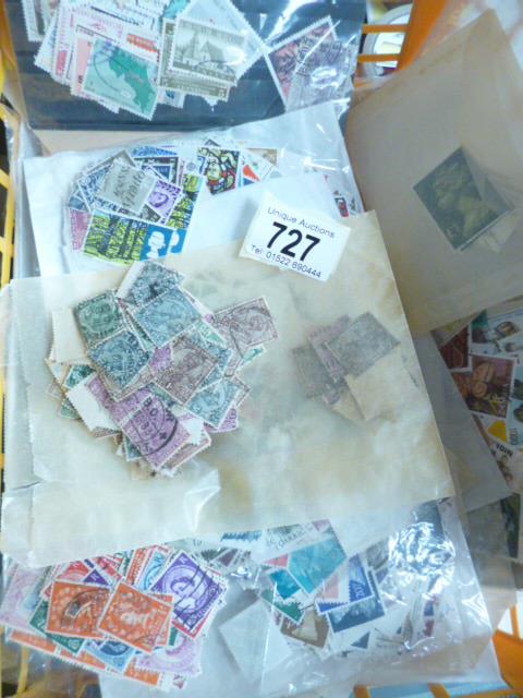 A plastic basket of GB and world stamps