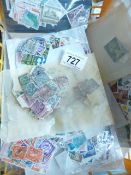 A plastic basket of GB and world stamps