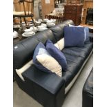 A blue & white sofa & cushions