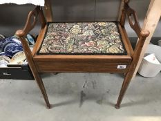 An Edwardian inlaid mahogany piano stool with tapestry top