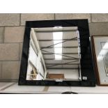 A square bevel edged mirror with bevelled black glass frame