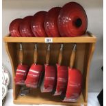 A set of 5 Le Creuset saucepans with rack.