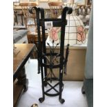 A wrought iron umbrella stand