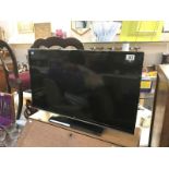 A JVC 32" LED smart TV with remote control (remote in office)