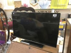A JVC 32" LED smart TV with remote control (remote in office)