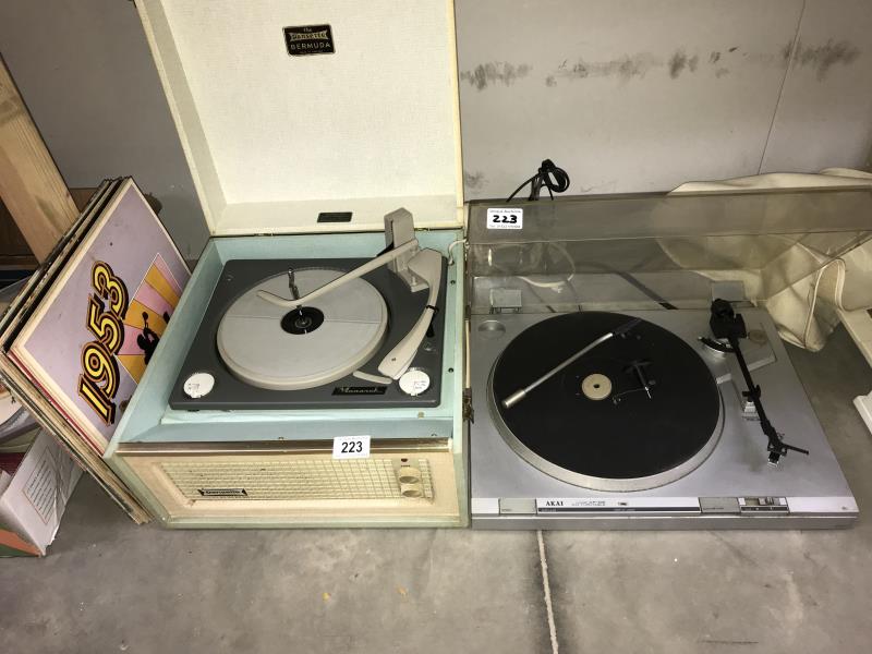 A vintage Dansette Bermuda record player, Akai APD2 turntable with a quantity of records.