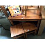 A stained pine table and 2 stools