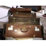 3 vintage leather suitcases and a satchel