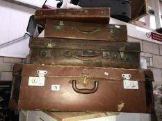 3 vintage leather suitcases and a satchel