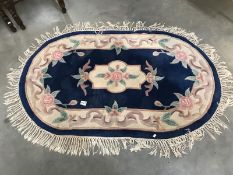 A blue flowery oval rug