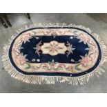 A blue flowery oval rug