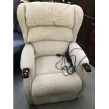 A cream fabric electric reclining armchair