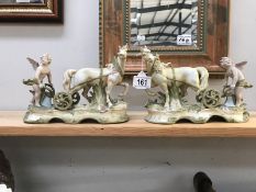 A pair of cherub figurines ploughing with horses.