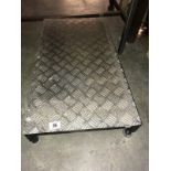 An aluminium checker plate work stool