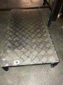 An aluminium checker plate work stool