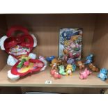 A collection of vintage plastic, care bears, and carry case.