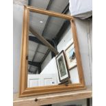 A large pine framed mirror.