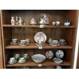 Three shelves of Chinese vases, cups and saucers, teapots etc.