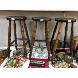 Three wooden bar/kitchen stools.