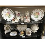 Two shelves of pottery and porcelain, including continental figures, ribbon plates etc.