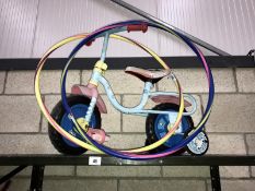 A child's bike and 2 hula hoops