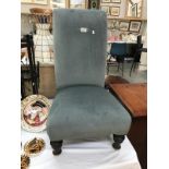 A blue draylon covered nursing chair with turned legs