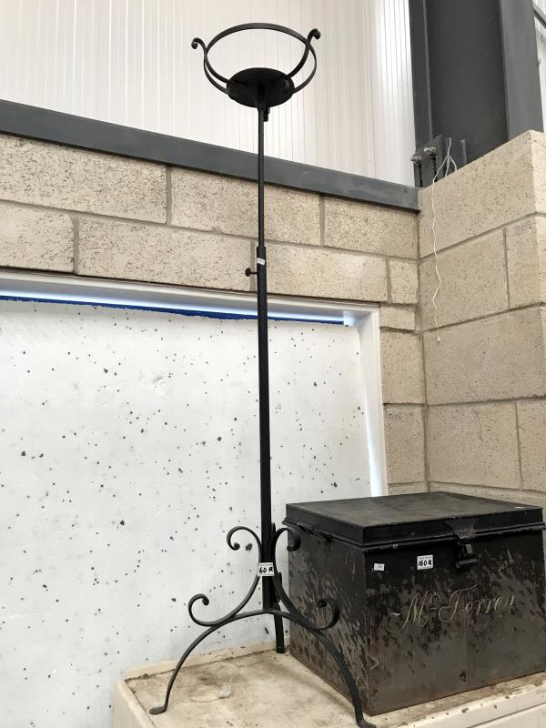 A wrought iron extending candle stand