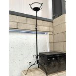 A wrought iron extending candle stand