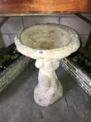 A cherub bird bath