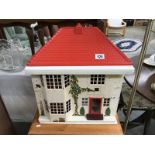 A Tri-Ang dolls house with furniture