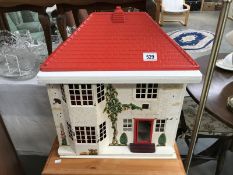 A Tri-Ang dolls house with furniture