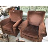 A pair of brown suede effect armchairs